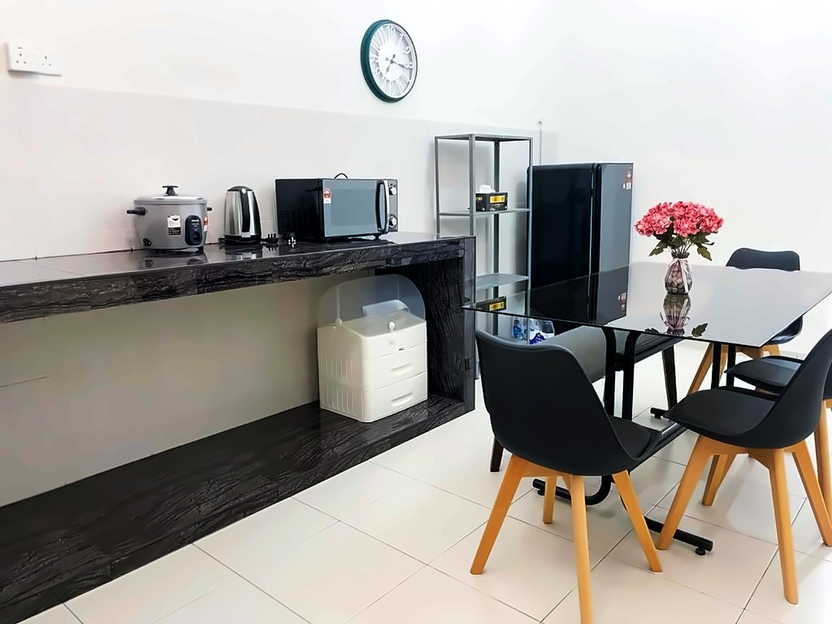 Kitchen counter with appliances beside a glass dining table
